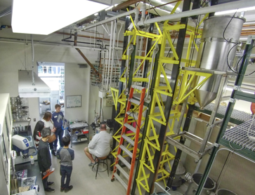 Figure 2.  Students and parents observe equipment for the gas atomization of metallic powders.